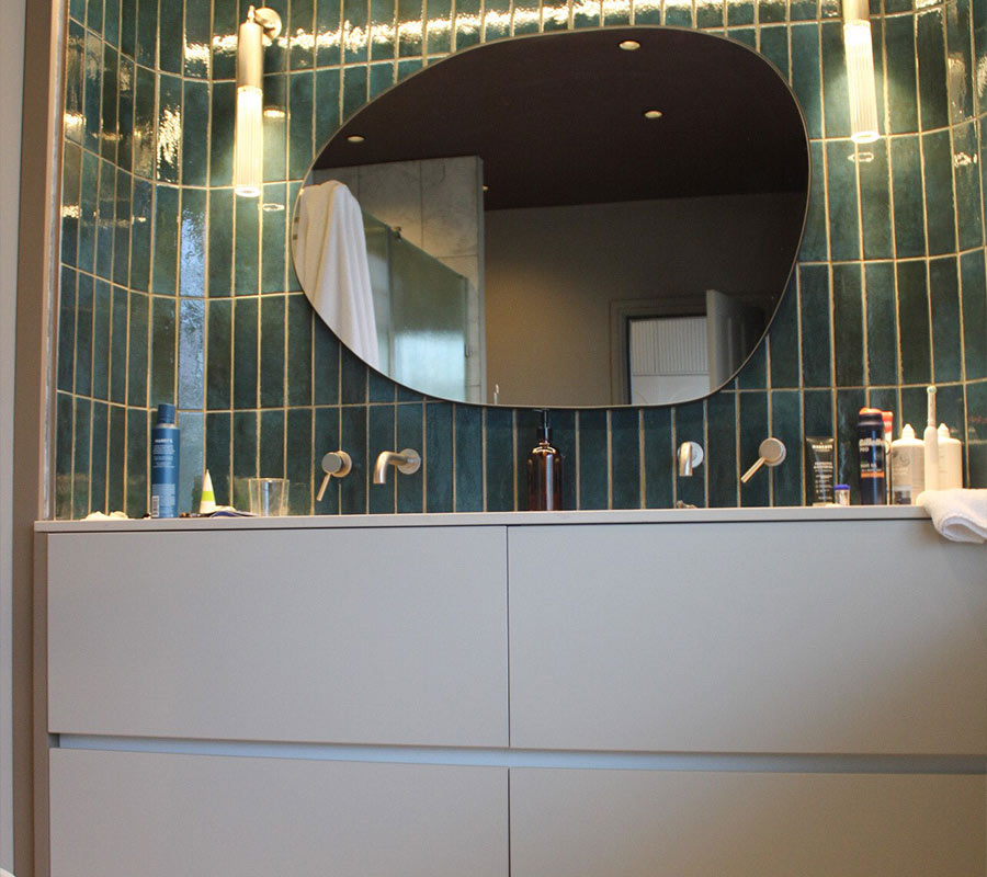Green gloss tiles, double vanity and pebble mirror